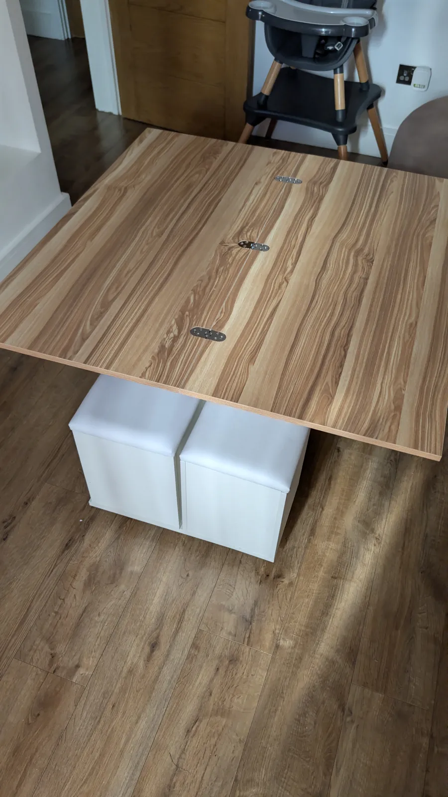 Wooden table assembled over storage cubes