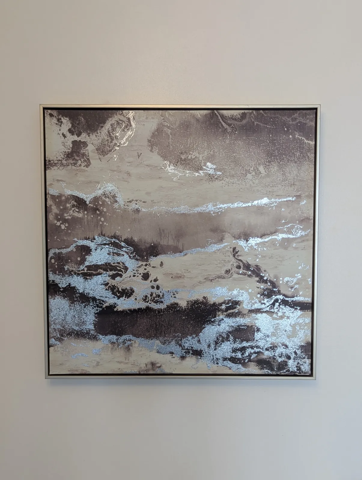 Large framed canvas hung on a living room wall